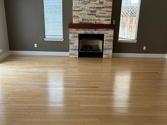 The lovely stone-faced fireplace gives the focal point to the living room.
