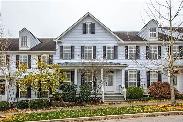 Front facing square with rocking chair front porch