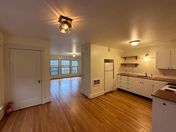 View from dining room, of living room and kitchen. Plus 2 storage closets