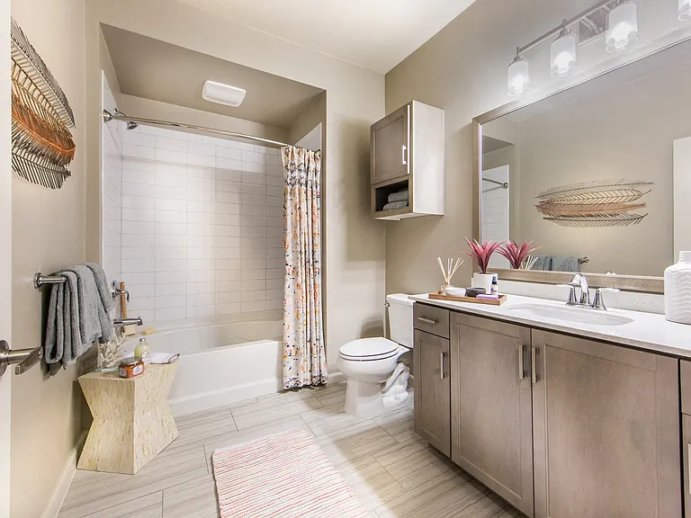 Spa-inspired bathrooms are complete with quartz countertops and custom framed mirrors.