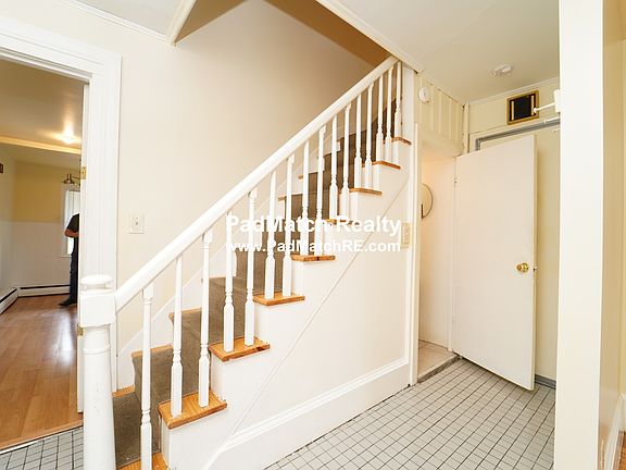 Stairs in hallway and half bathroom entrance