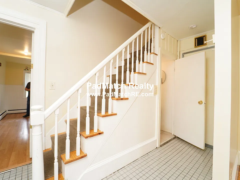 Stairs in hallway and half bathroom entrance