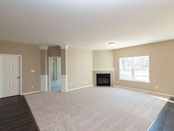 Spacious, open great room features corner fireplace.