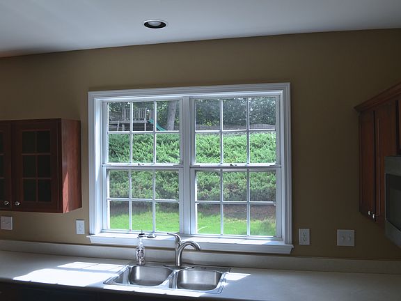 Kitchen looking out on the two level backyard with tree fort