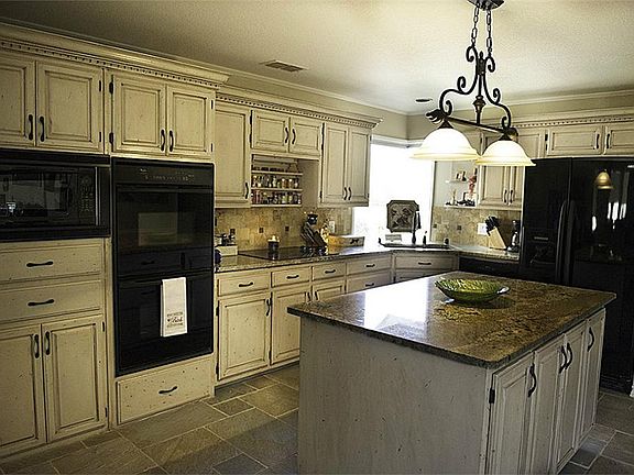 Large custom kitchen with granite counter tops.