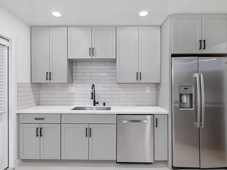 Includes a Bosch dishwasher, clean matte black fixtures, and dimmable recessed lights.