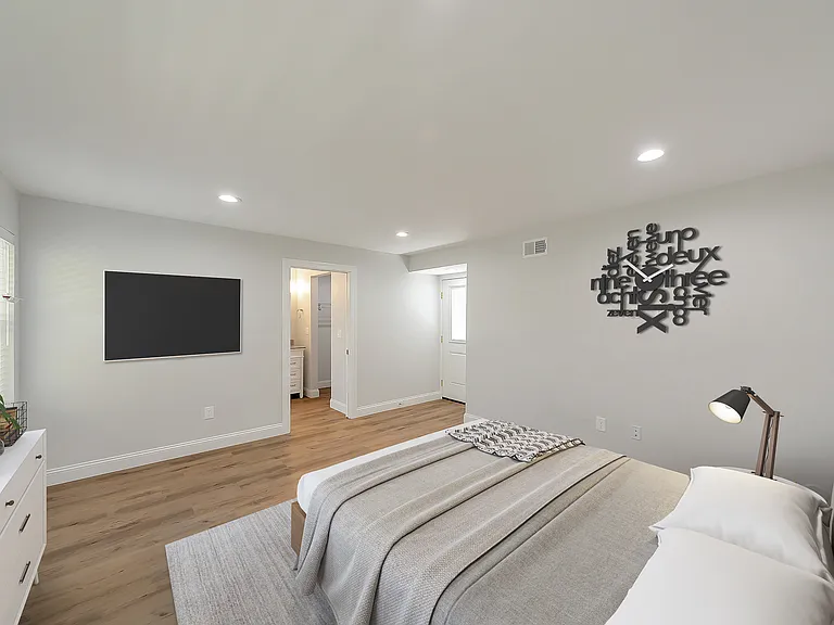 Spacious primary suite with direct access to private outdoor yard.