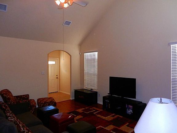 Huge den with ceiling fan and engineered hardwood floors