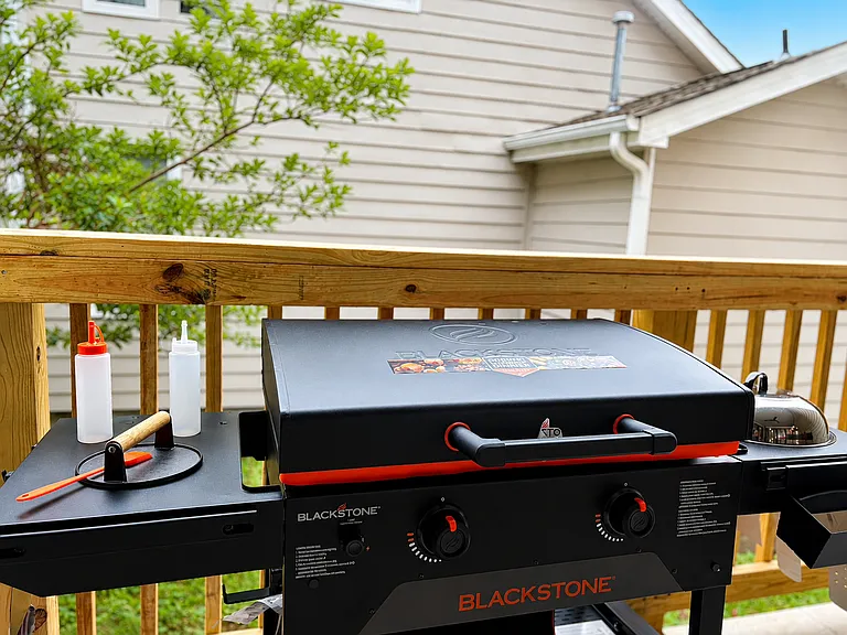 Step outside from the family and dining room directly onto your covered deck dining area with Blackstone grill, perfect for breakfast, dinner, and relaxed outdoor meals.