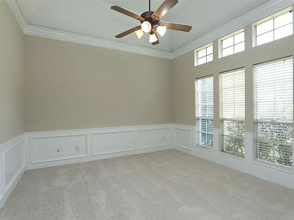 Just inside the front door is a large study with crown moulding and wainscotting. The ceiling fans have also been replaced. Work from home in style!