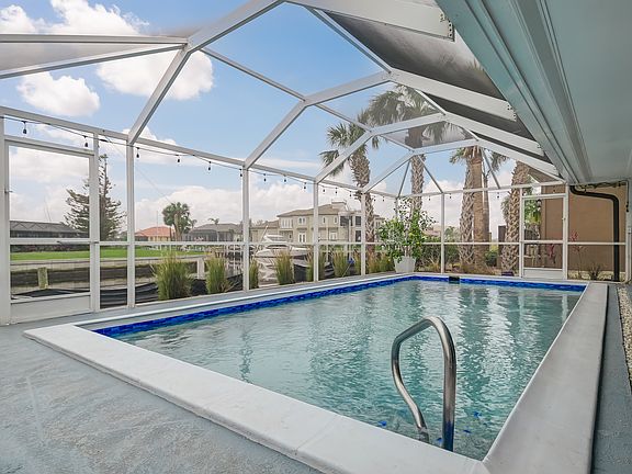 Heated pool with water views and screend-in lanai