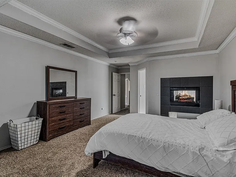 Recessed fireplace with dark tiled surround and hearth