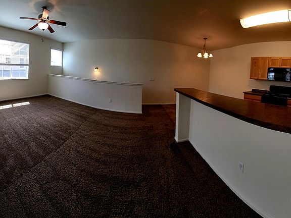 The "Sunlight" unit has a stunningly BRIGHT living room with high ceilings, large windows, and a ceiling fan.