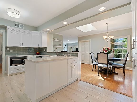 Renovated White Kitchen with Custom Cabinetry, Huge Breakfast Area and Bar Seating