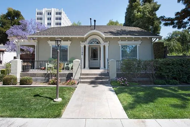 Front entry with a broad sitting porch facing towards sunsets.