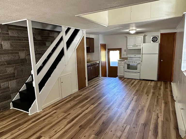 All one room kitchen and living room. Appliances are included. Pantry and under stairs storage.