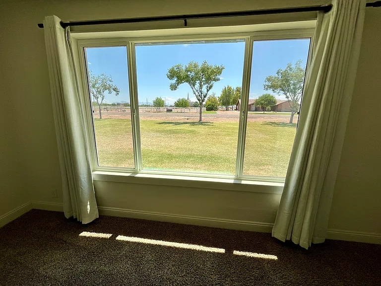 Extremely large window in 3rd bedroom with great views of the front yard and open space.