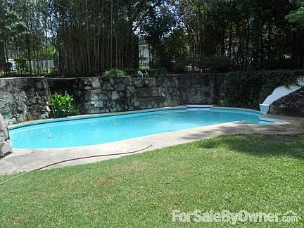 Unique pool with waterfall, slide and cliff for jumping off! Kids love this.