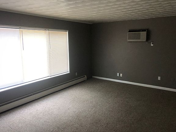 Living room with large window overlooking area on 2nd floor.