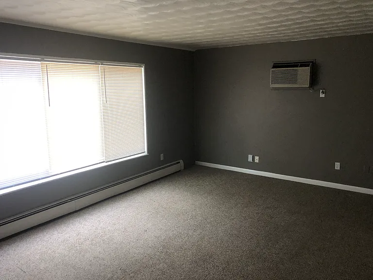 Living area with large window looking over area on 3rd floor