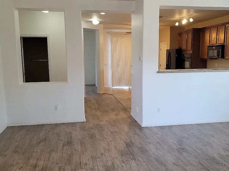 Downstairs half bath. Under stair storage on the left.