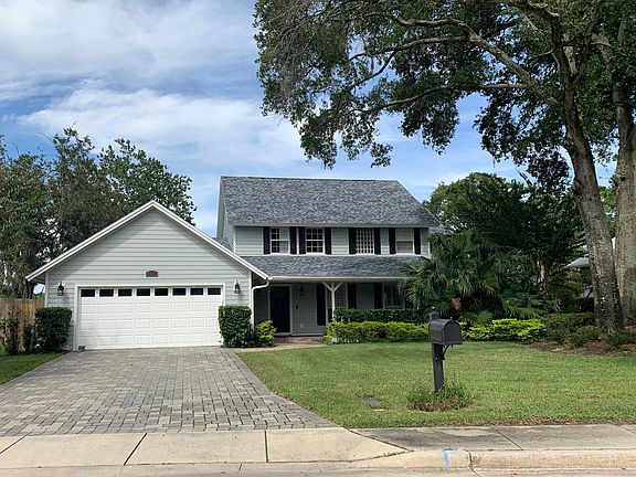Front of home with mature oaks.