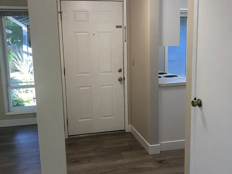 Entry hall with DR off to left and kitchen off to right. Also storage closet.