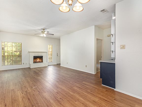 Living room with fire place and wet bar.