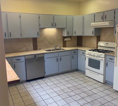 Kitchen. Stone counters and backsplash. tiled floors.