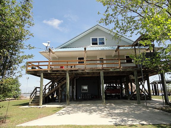 Back of house
						:
						Great Sunsets.Parking under house. Large storage utility room.