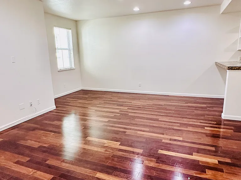 Spacious Living Room with hardwood flooring and recessed lighting