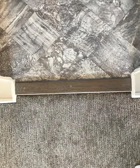 Gorgeous flooring. Kitchen above threshold and soft very nice carpet below.