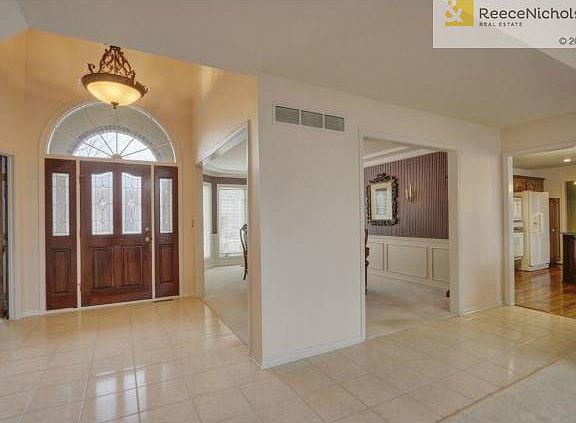 Beautiful arched glass entry with tile floor.