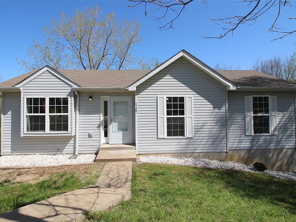 Welcome Home!  Beautiful new landscaping which has a white rock flower bed around the entire house.