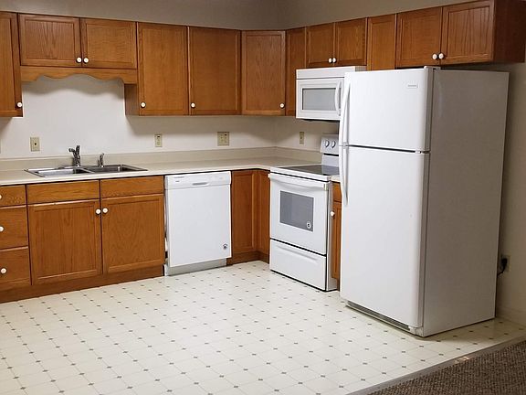 Large kitchen area with lots of cabinets and counter space.