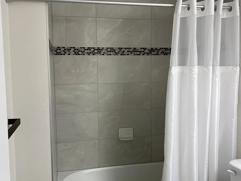 Bathroom #2 with Hotel Style Shower curtain and high-end towel bars.