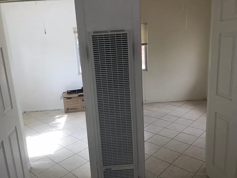 Wall furnace between two rooms.