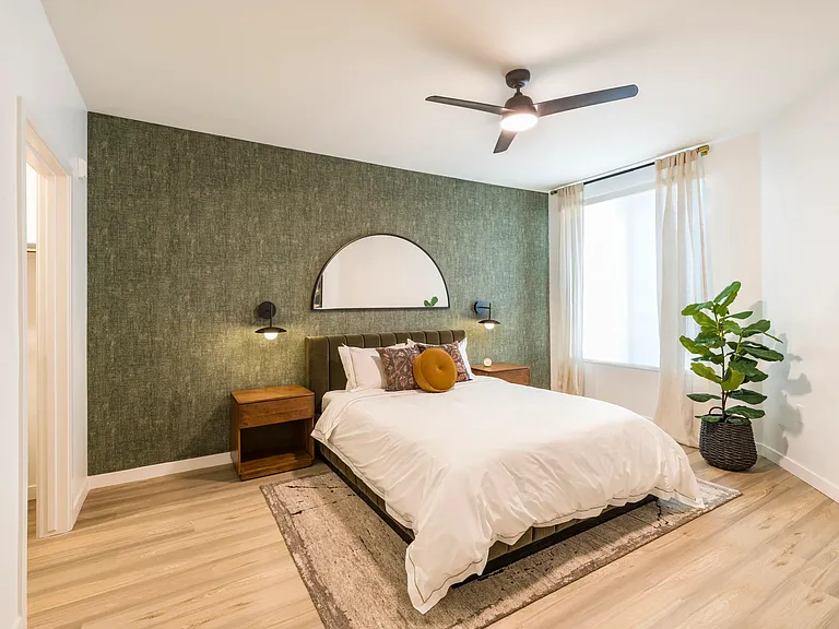Inviting and refined, bedrooms at Modera Higley Commons pair natural textures with soft light for an effortlessly elevated feel.