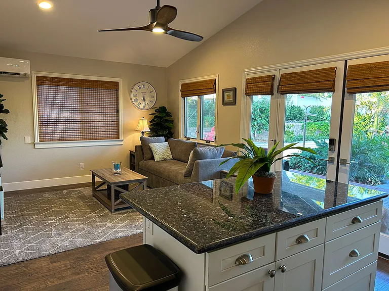 Enjoy the privacy of a detached cottage featuring a kitchenette and a cozy living room with a lounge that converts into an extra queen bed_perfect for extra guests or relaxing in style.