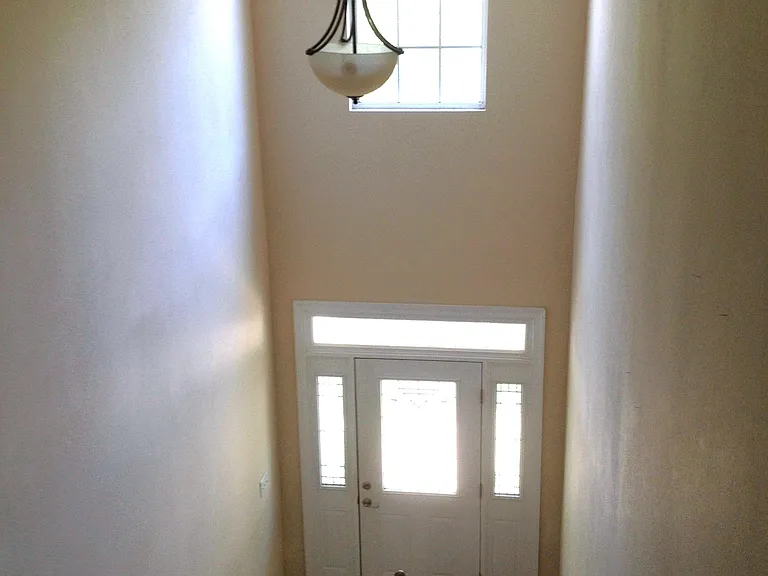 View of the front door from the top of the stairs.