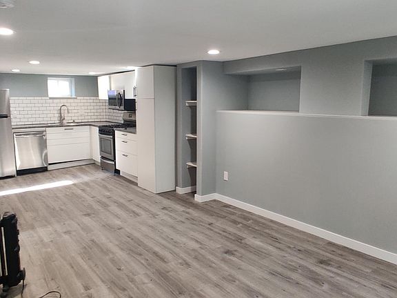 Living room, storage nook, kitchen and coat closet