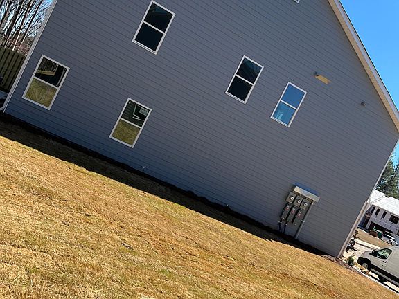 Side of home with the beautiful natural sunlight available. Large open area available between homes.