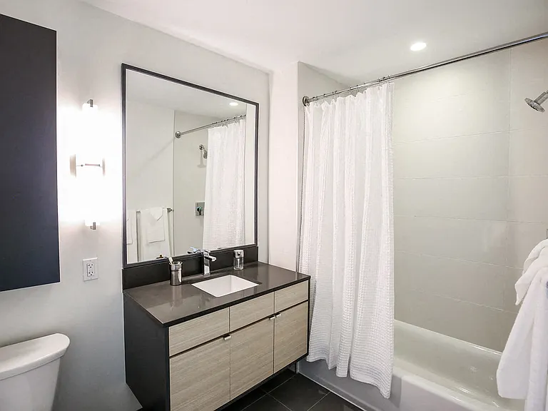 The modern design elements are carried through the bathroom with floating vanities