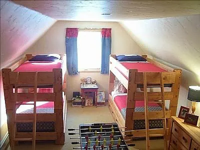 Upstairs bunk room with queen futon, 4 twins and 2 twin trundles