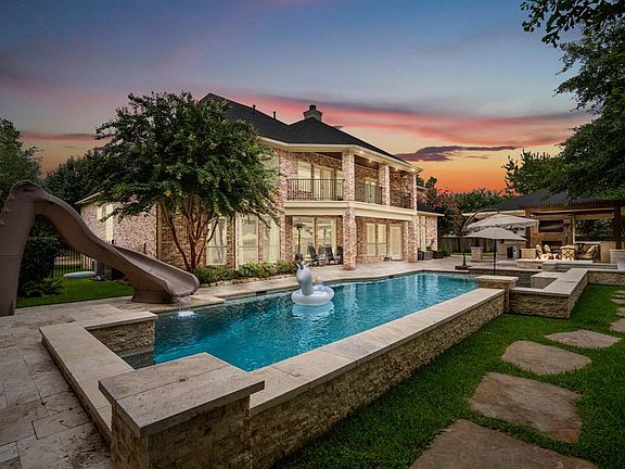 Enjoy outdoor living in the beautiful 3-year old sparkling pool & raised spa! As well as a covered summer kitchen with fireplace and travertine flooring. The roof was replaced in 2020.