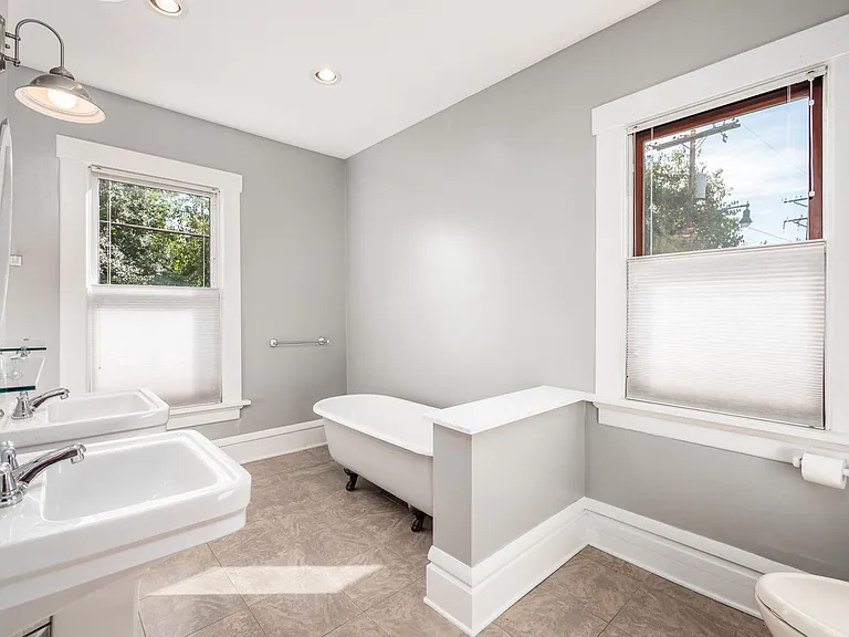 Bathroom has both south and west windows, cellular blinds with up/down feature. Separate shower and clawfoot tub, two pedestal sinks.