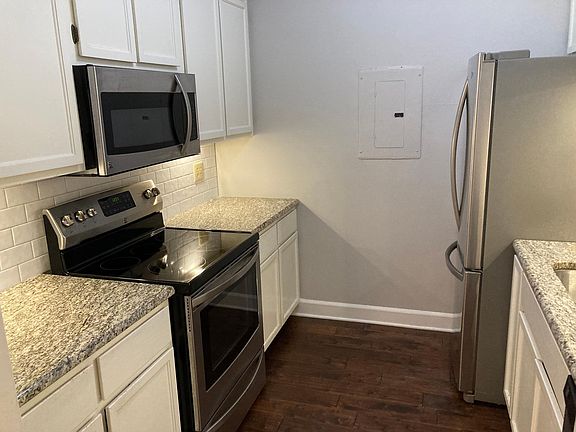 Kitchen with tons of cabinet space, clean white subway tile backsplash, stainless steel appliances, and beautiful granite countertops