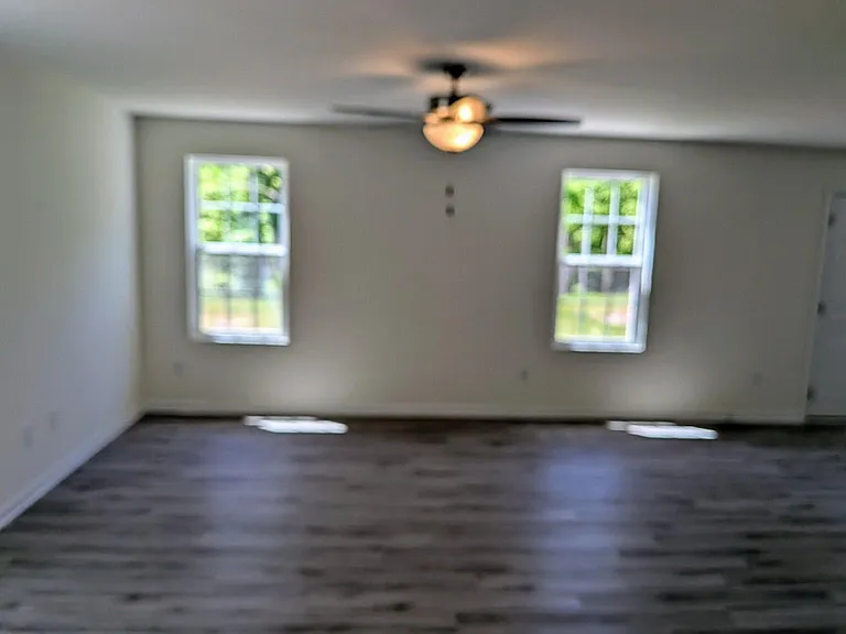 Spacious living room on the main level with an open-concept design, perfect for relaxing, entertaining guests, or spending time with family.