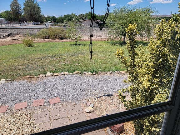 Front yard view, nice lawn with three willow trees. Yes the train passes right in front of property.