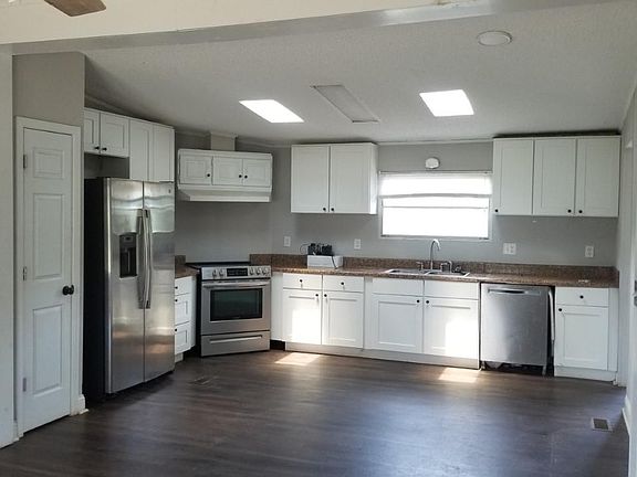 Large kitchen, stainless appliances including dishwasher. Lots of storage, open to front room. Laundry room and back door onto deck, off kitchen.
